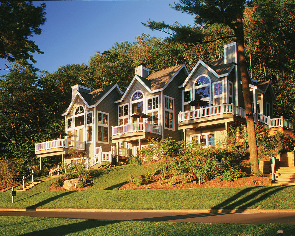 Modern Michigan homes surrounded by trees in a quiet residential neighborhood